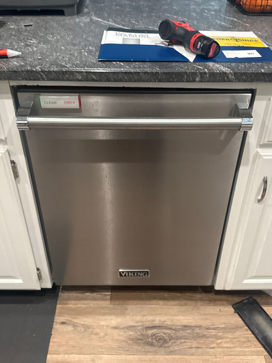 Dishwasher repair technician working on a built-in dishwasher in Fort Worth TX