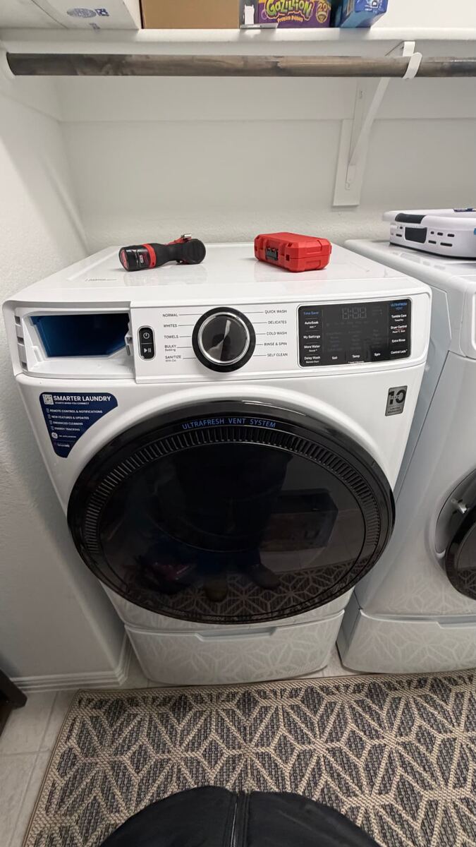 Dryer repair technician servicing an electric dryer in Fort Worth TX